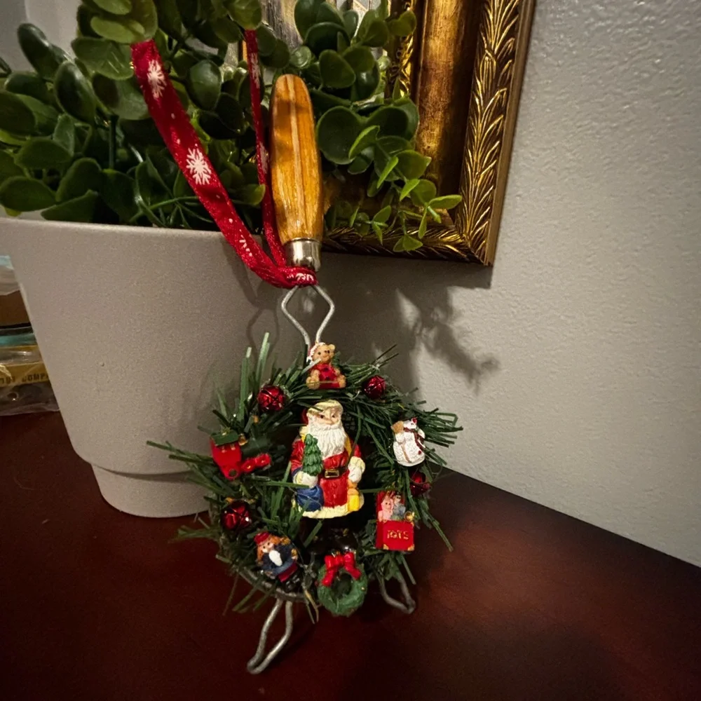 Handmade Santa Holiday Wreath on an old tea strainer.